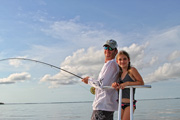 dad is fighting and his daughter is learning to fly fish