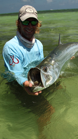 Capt. Jeff Legutki holds a fly caught Tarpon by the jaw.