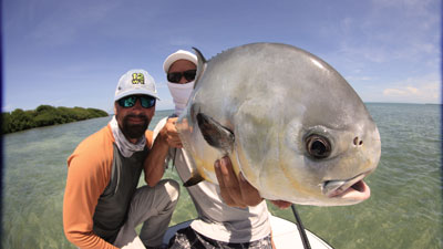 Capt. Shane Smith shows off a big permit on fly