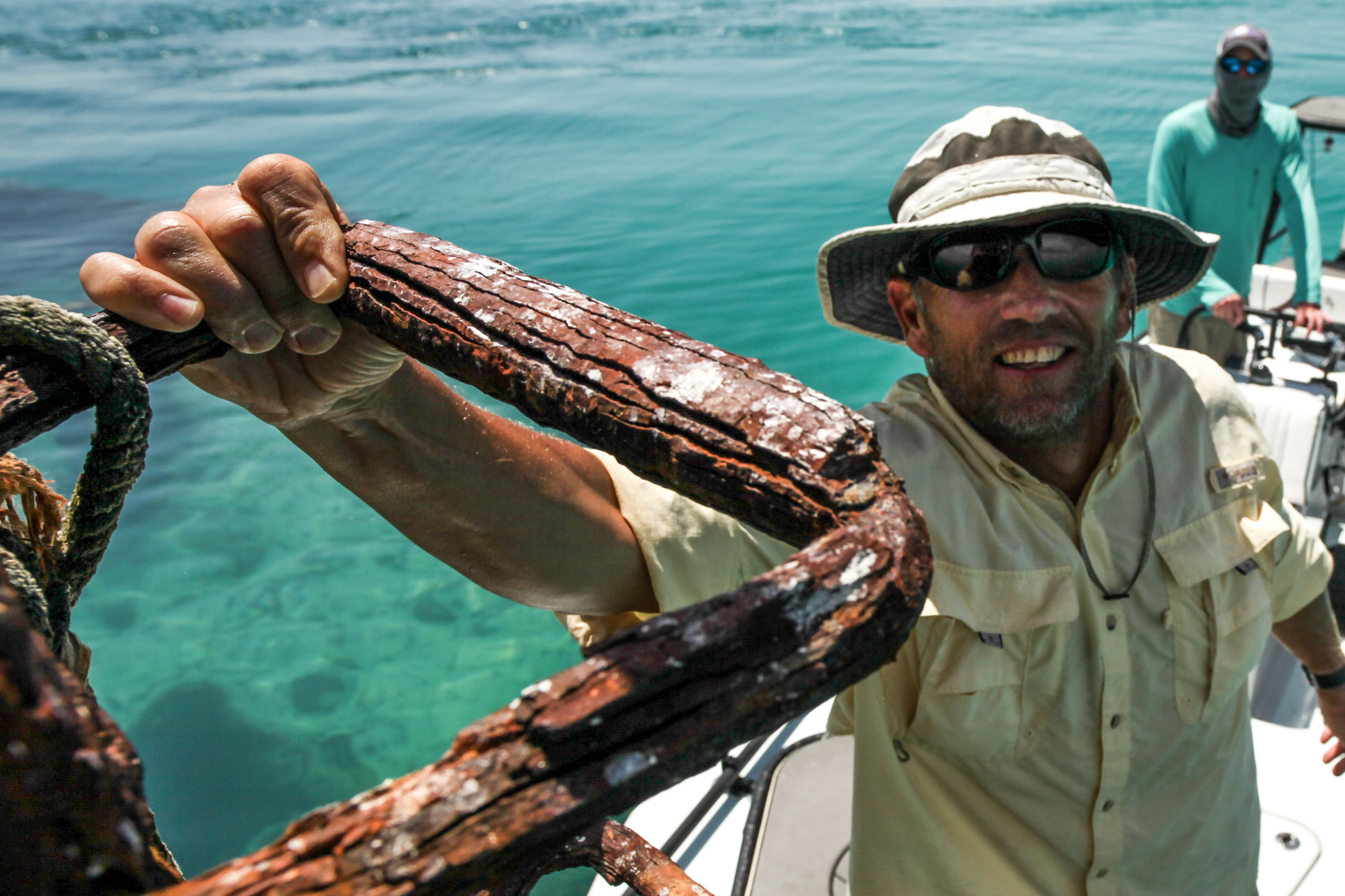 Angler Terry G hangs on to a rusted mast of an old shipwreck off the Marquesas keys